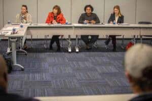 Advocacy panel discussion at CAES News conference with diverse speakers in a professional setting.