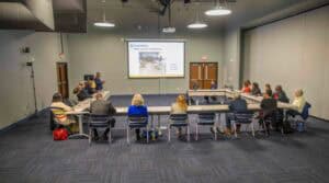 A comprehensive business meeting or training session in a modern conference room with attendees seat.