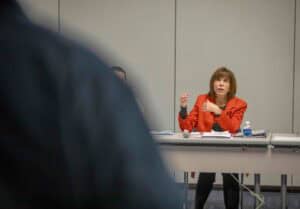 Engaged woman speaking at a professional conference or meeting.