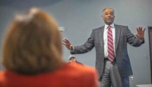 Engaged speaker presenting during a professional conference or seminar on leadership and communicati.