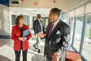 Engaged business professionals having a discussion in a modern office lobby.