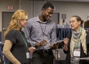 Engaged professionals discussing at a conference or seminar for networking and collaboration.