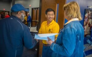 People engaging in a conversation at a community event or conference.