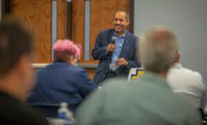 Engaging speaker at a conference delivering a presentation to an attentive audience.