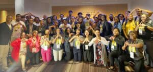 Empowered group of diverse professionals at CAES News conference, celebrating teamwork and success.