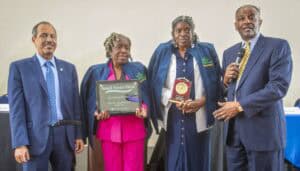 Empowered women and award ceremony at Small Farms Week event in professional attire.