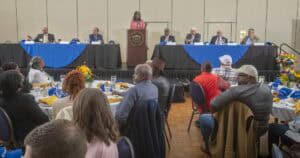 Engaging panel discussion at CAES News conference with diverse speakers and attentive audience.