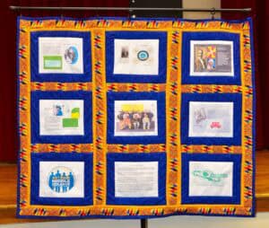 Brightly decorated display board showcasing various informational posters and artwork at CAES News e.