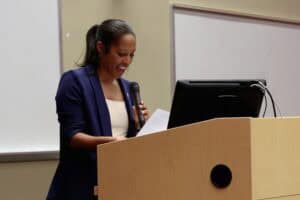Empowered woman giving a presentation at a conference or seminar.