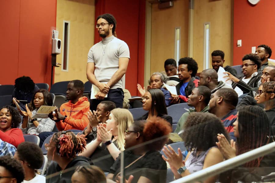 Engaged diverse audience at a seminar or conference in a modern classroom setting.