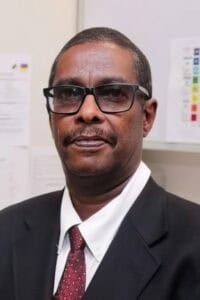 Confident professional man wearing glasses in office setting at CAES News.