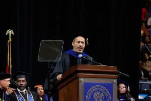 Graduation speaker at a university commencement ceremony delivering a speech.