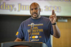 Empowered speaker at a conference delivering a presentation on leadership and community engagement.