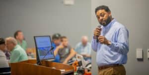 Engaging speaker presenting at a conference with an attentive audience.
