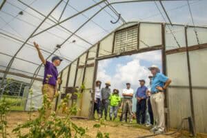 High school students and instructor touring a greenhouse for agricultural education and sustainable.