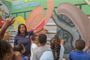 Protect Your Lungs educational display with children learning about respiratory health and lung prot.