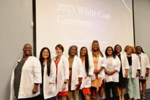 Group of healthcare professionals at 2023 White Coat Ceremony celebrating medical students.