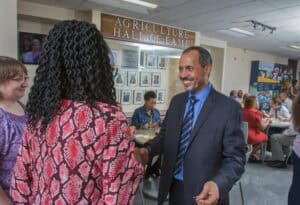 Handshake between two professionals at the Agriculture Hall of Fame event.
