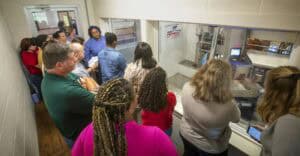 Group of diverse people watching a live broadcast at a news station.