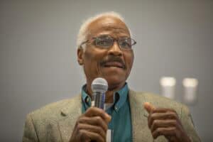 Empowered senior man speaking passionately at a conference or seminar.