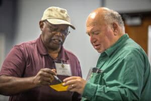Engaged professionals discussing documents at a conference or seminar.