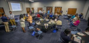 Networking event with professionals in a conference room, engaging in discussions and exchanging ide.