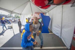 Exciting arcade game at CAES News event with children enjoying fun activities.