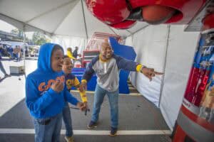 Explosive science demonstration at CAES News event with children and instructor.