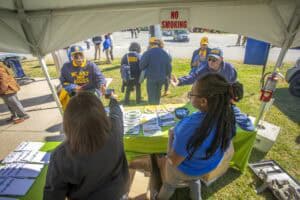 Community health fair booth promoting wellness and safety awareness outdoors.