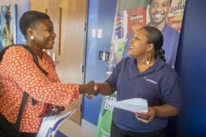 Friendly business handshake between two women at a corporate event, promoting networking and partner.