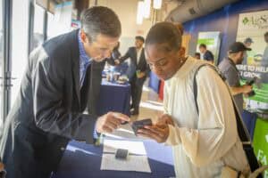 Innovative business professionals discussing at a conference booth for CAES News.