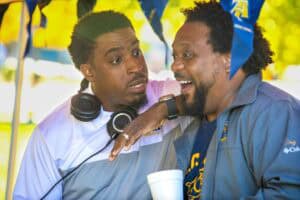 Two men engaging in a friendly conversation at an outdoor event.