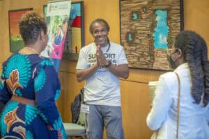 Engaged speaker sharing insights at CAES News event with diverse audience.