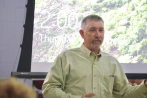 A man giving a presentation at a conference or seminar.