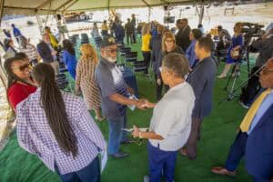 Business networking event on a boat dock with diverse professionals shaking hands.
