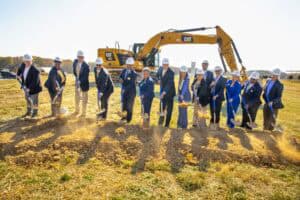 Earthmoving construction site with professionals and heavy machinery for infrastructure development.