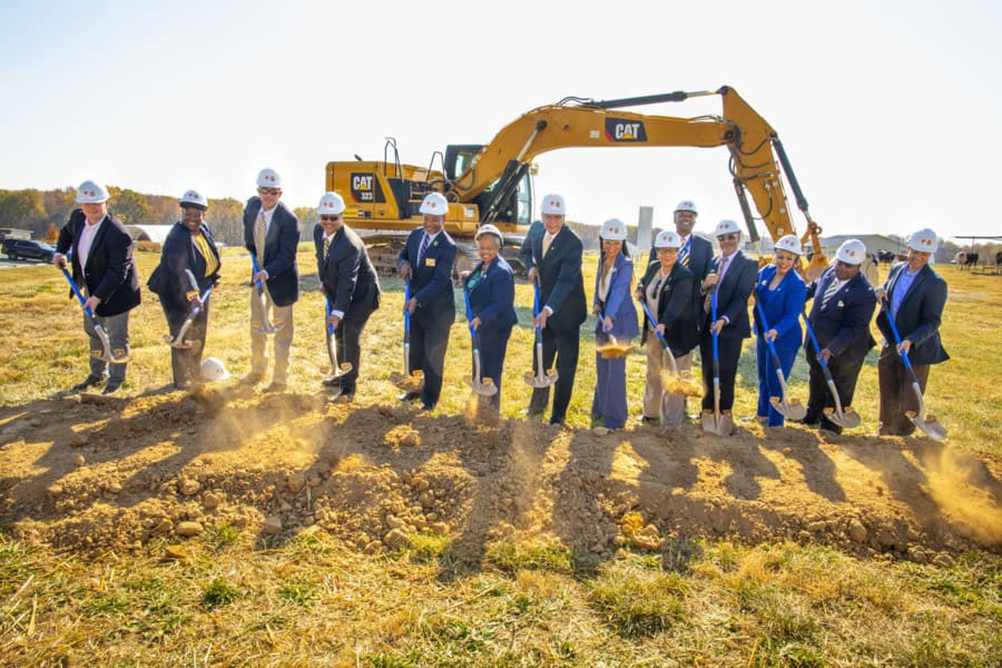 Earthmoving construction site with professionals and heavy machinery for infrastructure development.