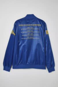 A detailed blue jacket with yellow text and patches, featuring a back design with "Name Cracks to Re.