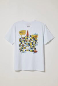Bright white T-shirt featuring a colorful, playful snake graphic with a yellow sign and vibrant desi.