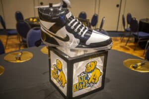 A large black and white sneaker display on a table featuring the NC A&T mascot.