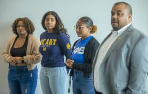 Empowered diverse group of women and man at a community event or meeting.