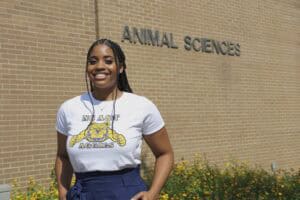 A woman smiling outside the Animal Sciences building at CAES News campus.