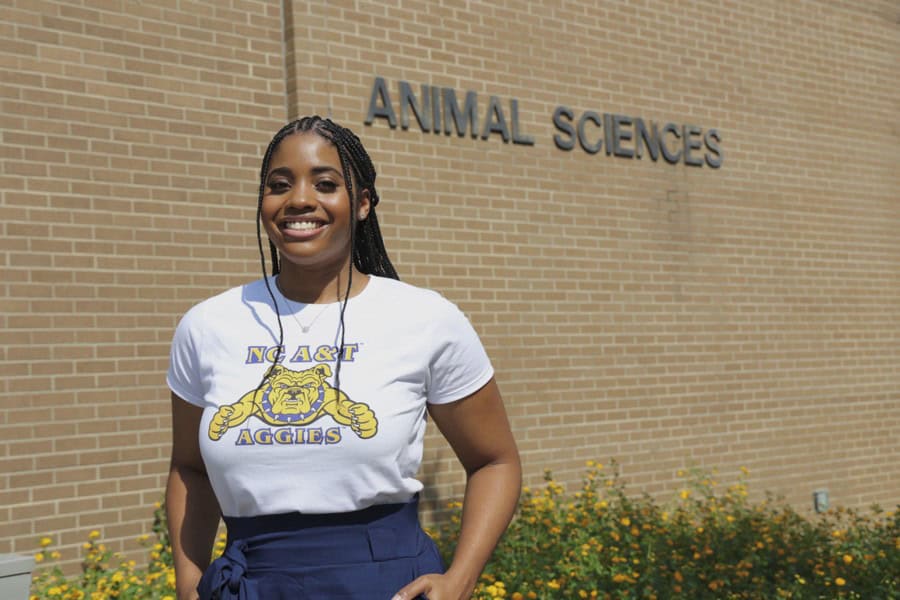 A woman smiling outside the Animal Sciences building at CAES News campus.