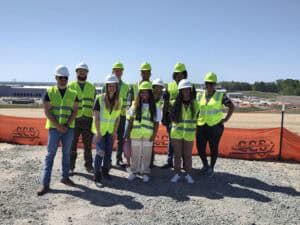 Construction team wearing safety vests and helmets at a construction site.