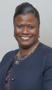 A woman smiling in professional attire for CAES News.