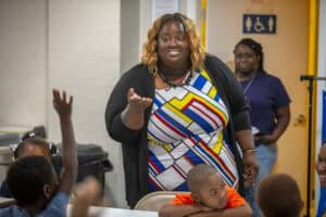 Accessible classroom discussion with diverse students and teacher engaging in learning activities.