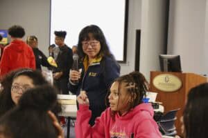 Empowering youth at a community event with diverse participants and engaging discussions.