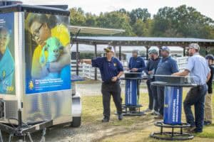 A student and instructor at a mobile learning station outdoors, promoting agricultural education and.
