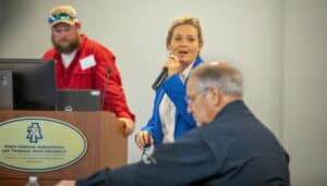 Engaged woman speaking at a conference with attendees and presenters at North Carolina Agricultural.