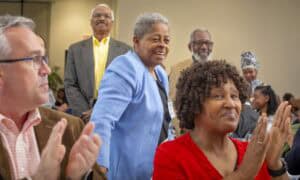 Empowered diverse group of professionals celebrating success at a conference.